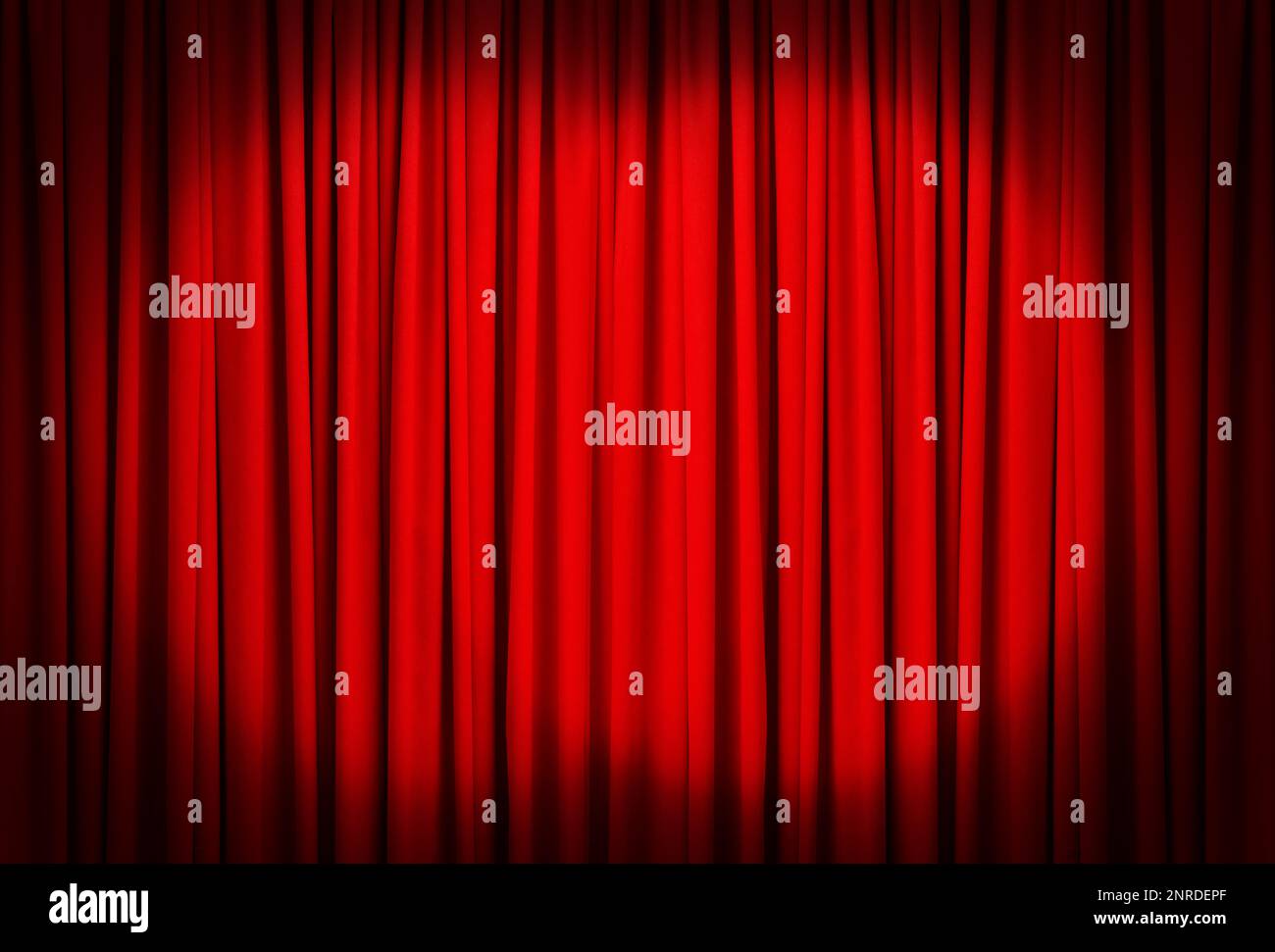 Spotlights illuminating closed red stage curtains. Start of performance Stock Photo