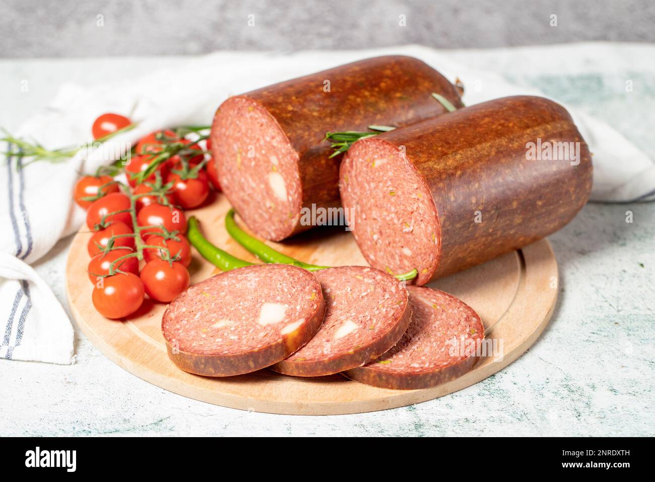 Beef sausage with cheddar. Raw grilled sausage on a wood serving board. Deli products Stock Photo