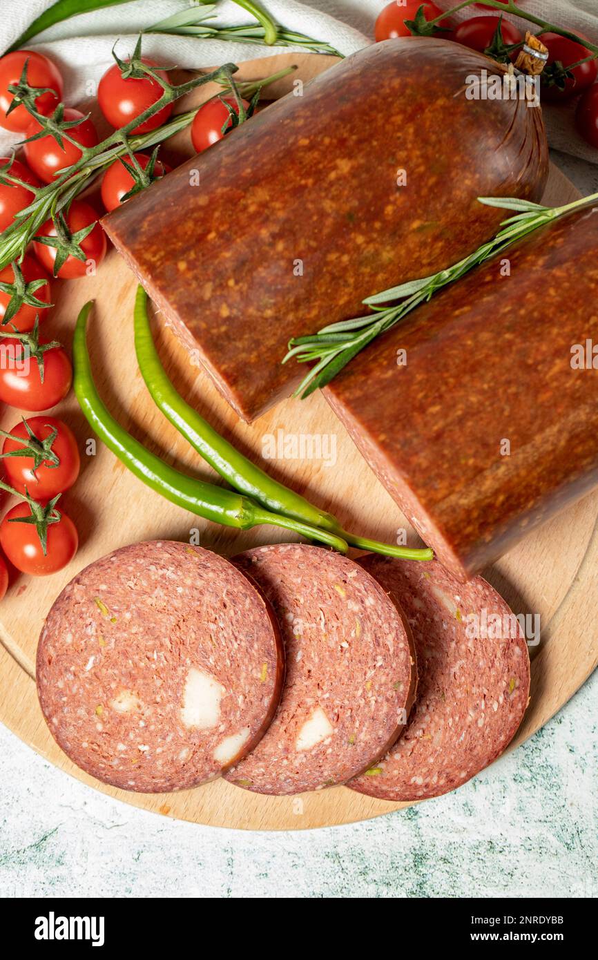 Beef sausage with cheddar. Raw grilled sausage on a wood serving board. Deli products. Top view Stock Photo