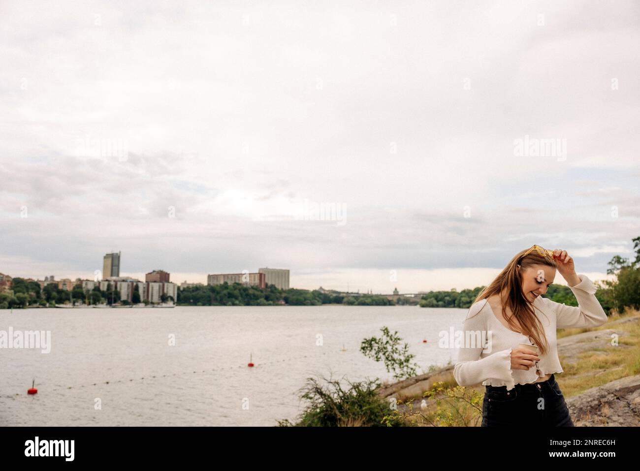 Woman standing in front of sea hi-res stock photography and images - Alamy