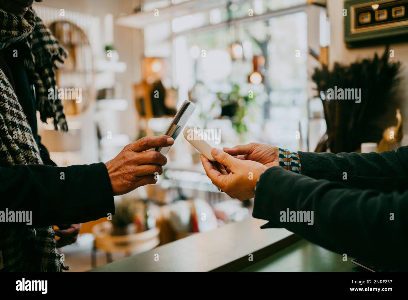 Male customer paying via tap to pay method while doing shopping at