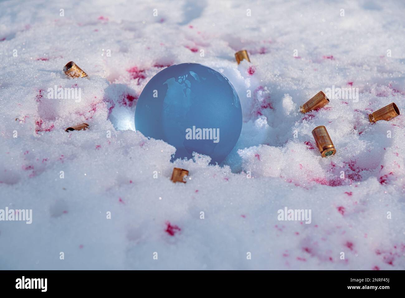 The concept of symbolism. crystal earth globe on snow with blood stains
