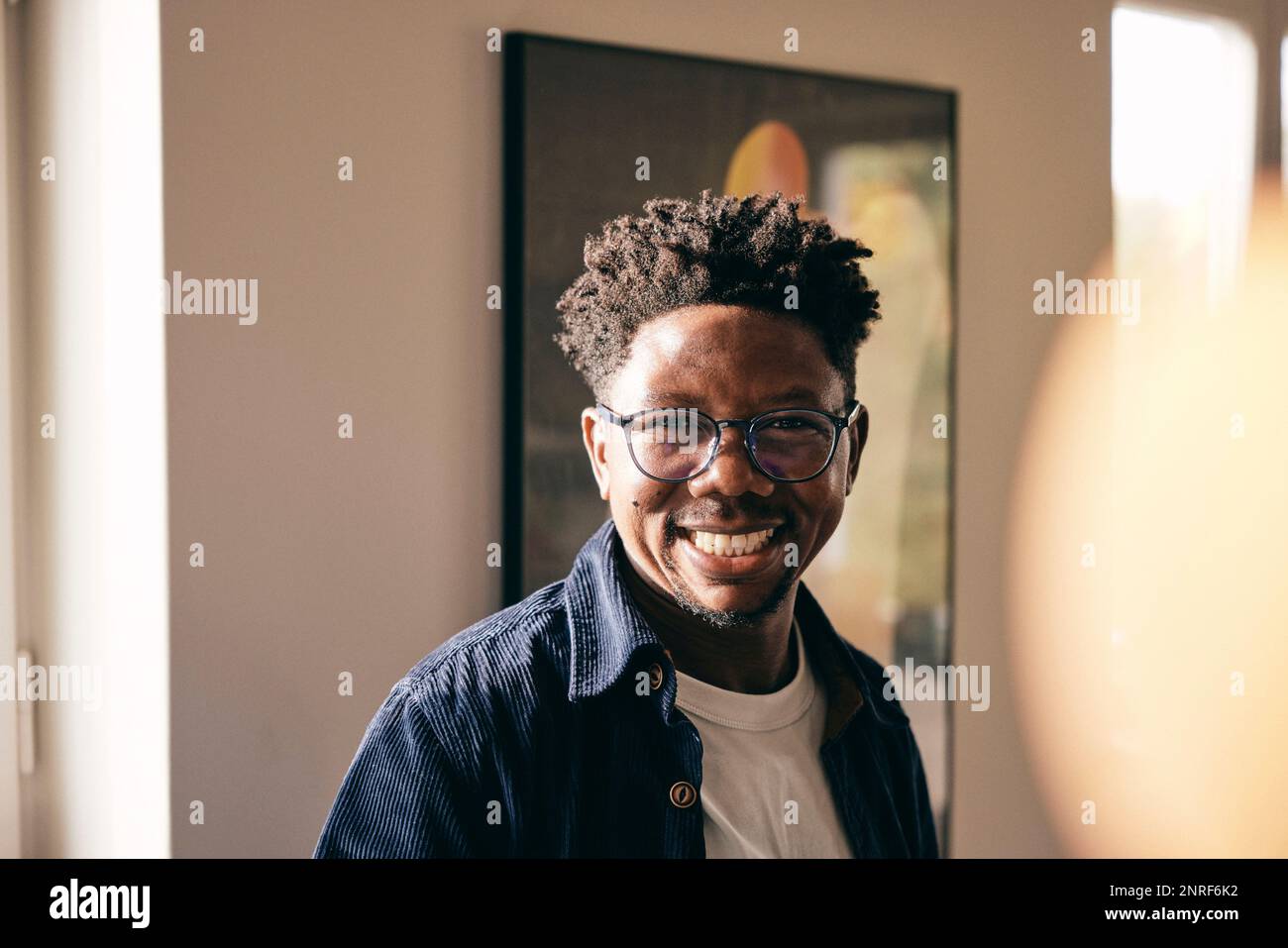 Portrait of cheerful man wearing eyeglasses at home Stock Photo