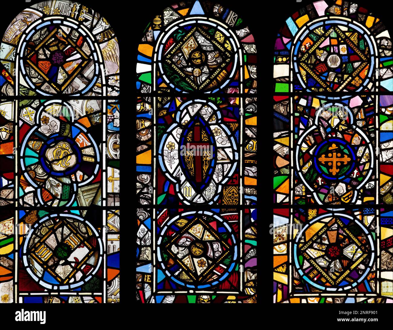 A triptych of the three Western windows in the Nave of St Mary's Church, Wreay, UK Stock Photo