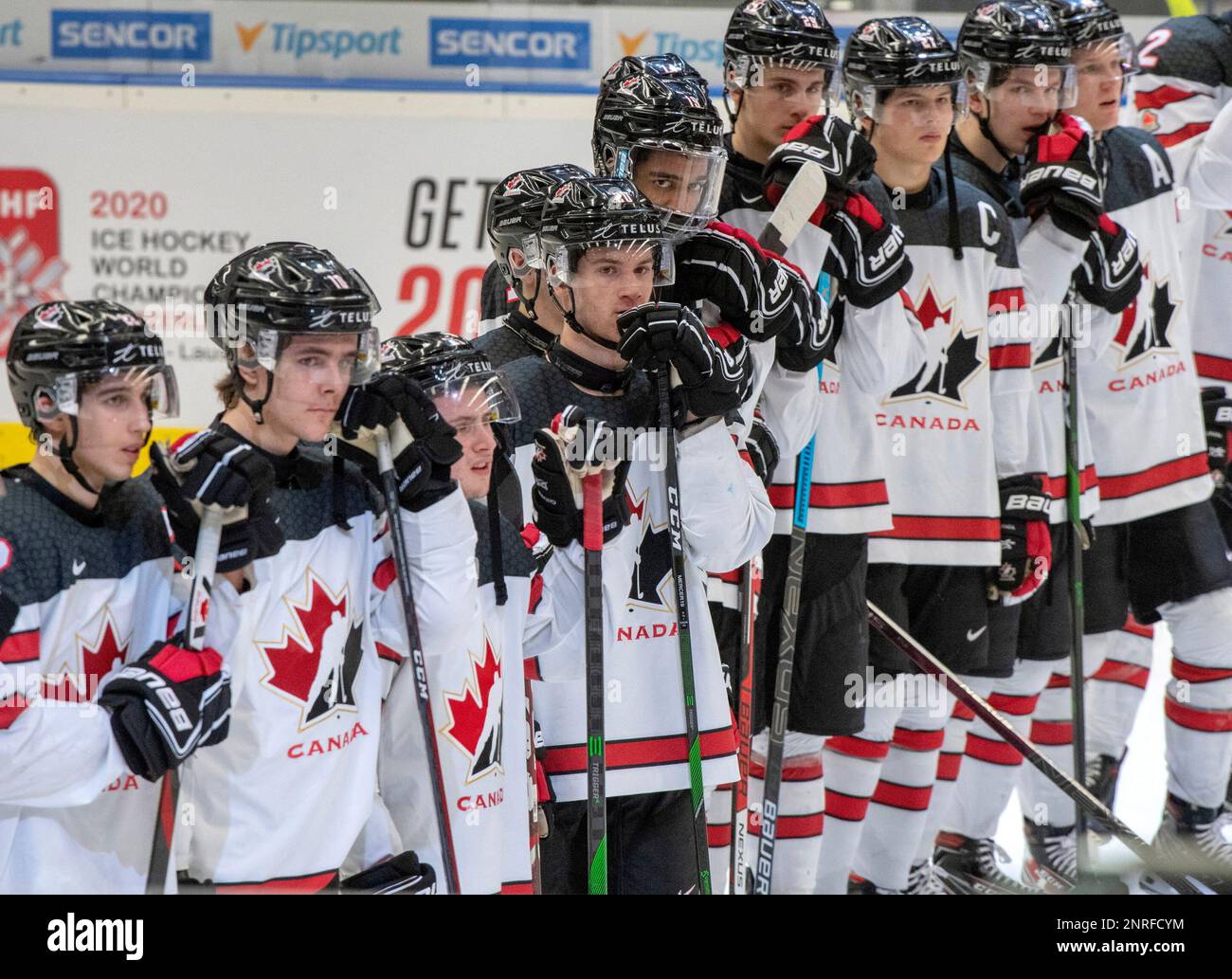 Team Canada players watch the post-game ceremony after losing 6-0 against Russia at the World Junior Hockey Championship, Saturday, Dec