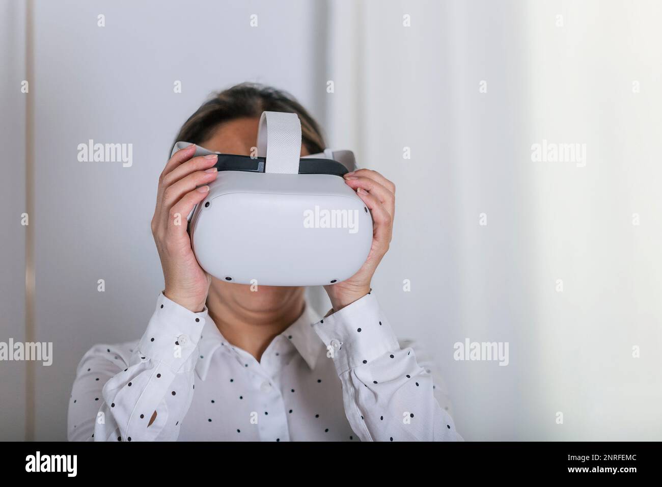 Young woman wearing VR glasses. Stock Photo