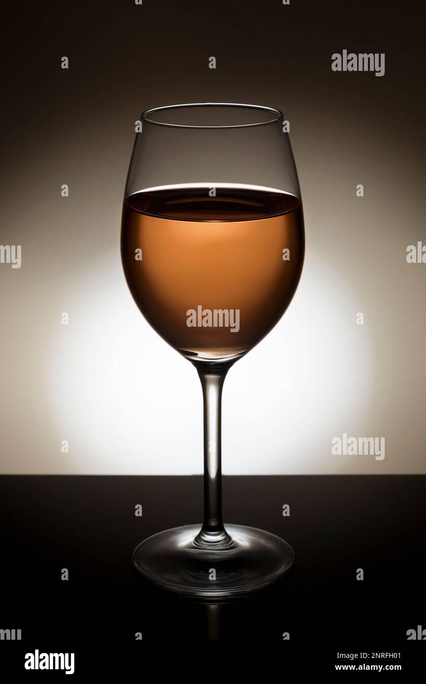 Rose wine in a backlit glass. Stock Photo