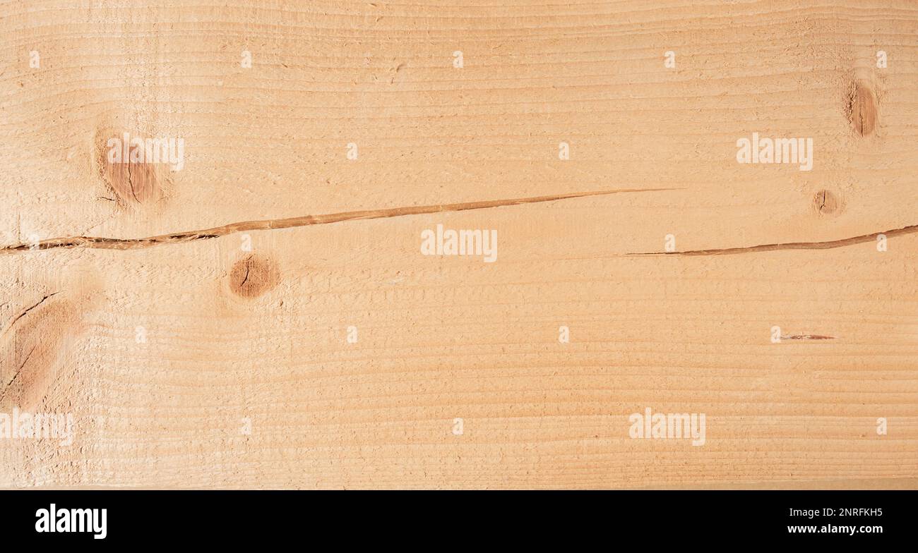 Bright pine board texture with knots and crack. Stock Photo
