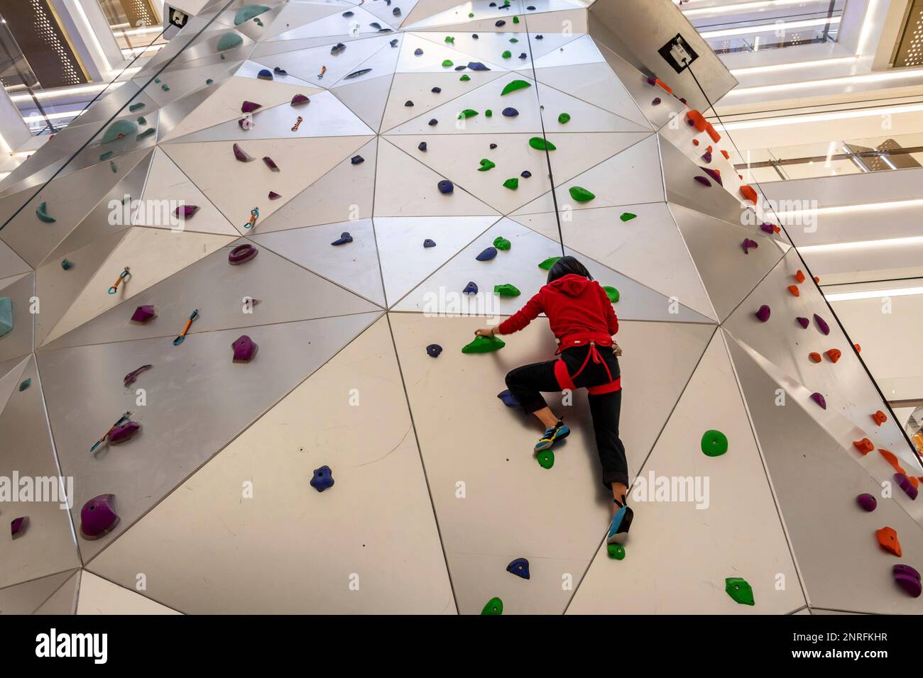 A girl tries the 55metertall climbing wall in a refurbished