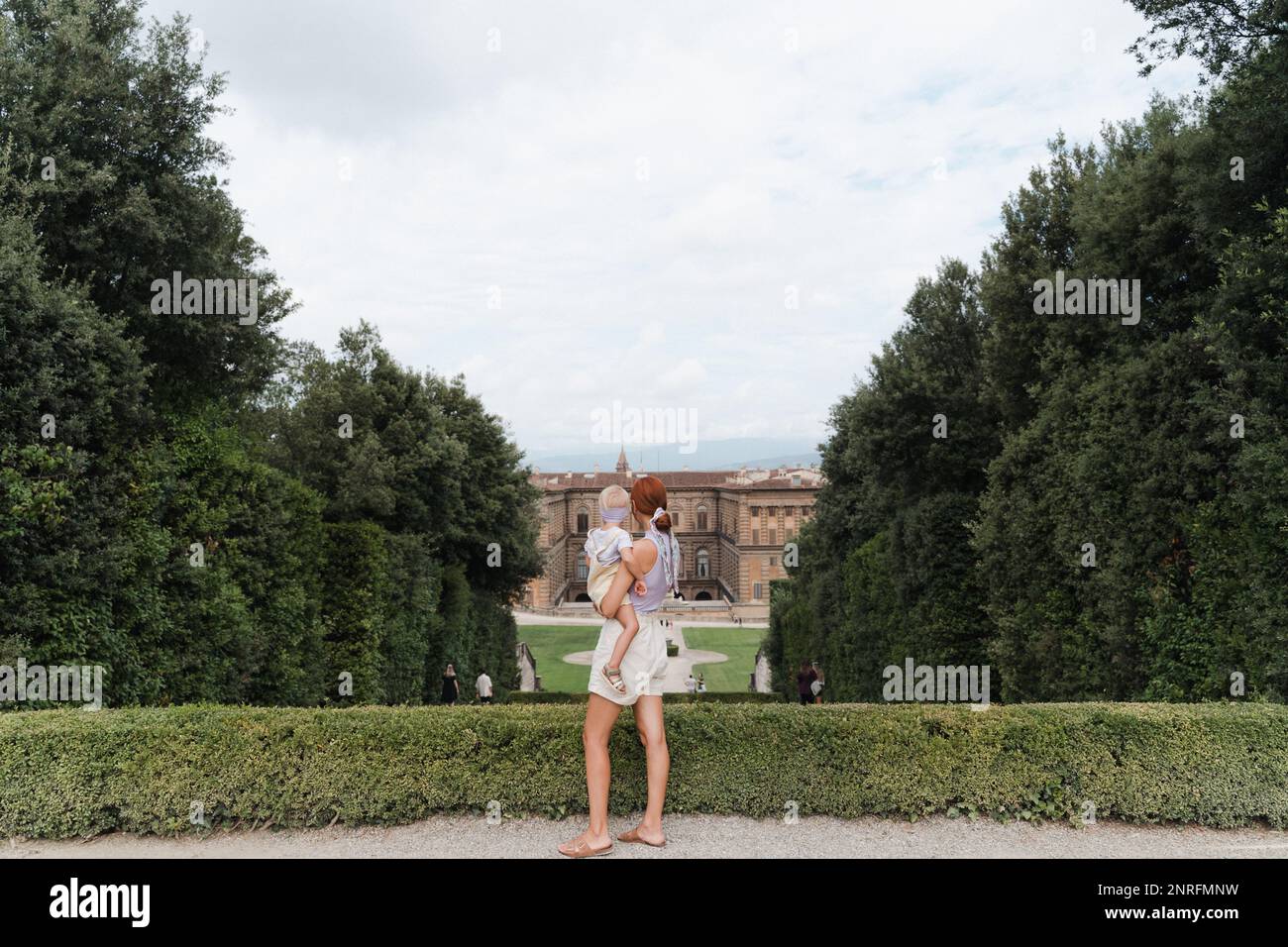 Woman with a toddler in her arms in the Boboli Gardens viewpoint Stock Photo