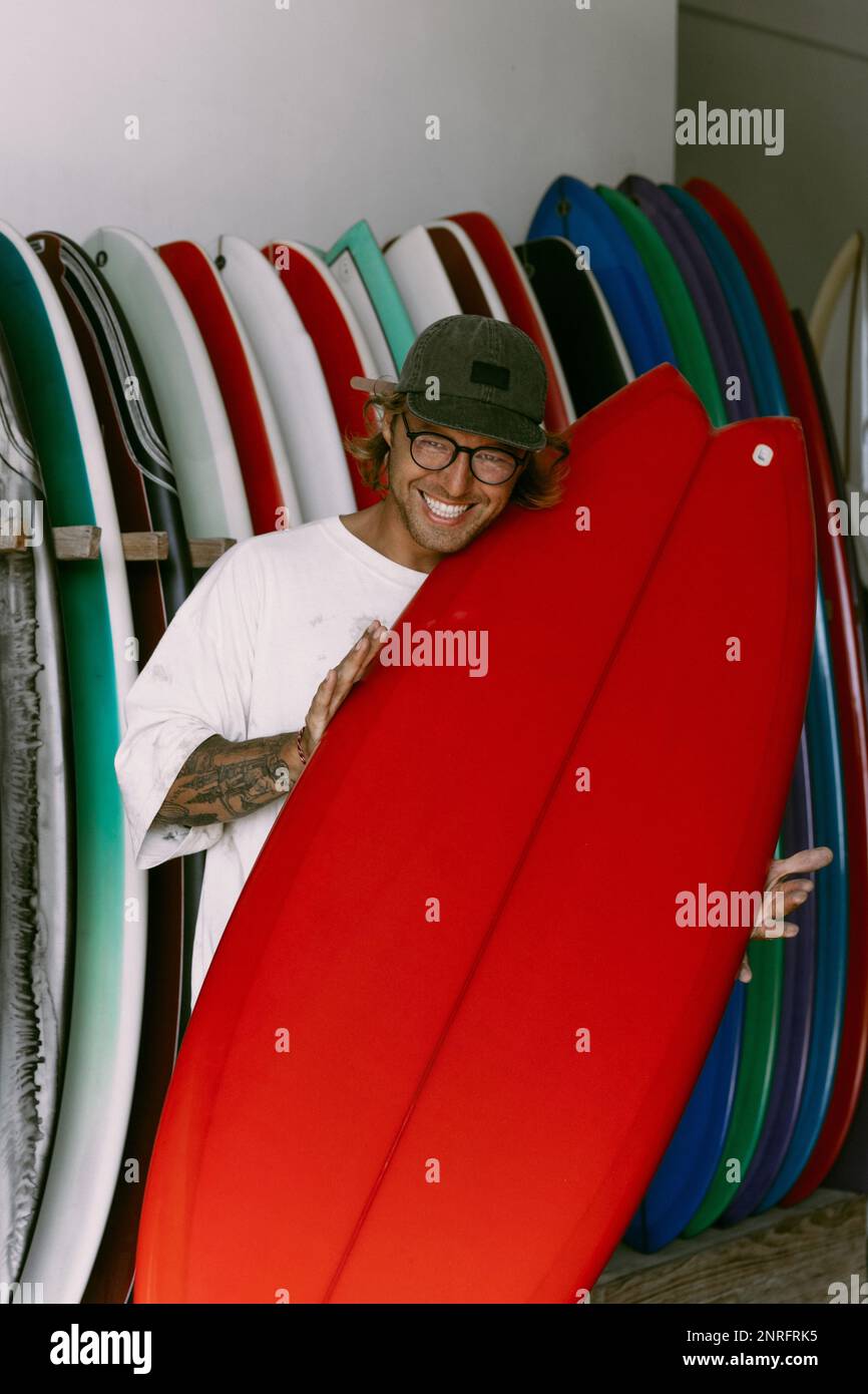 Man choosing a surfboard in a surfboard shop Stock Photo Alamy