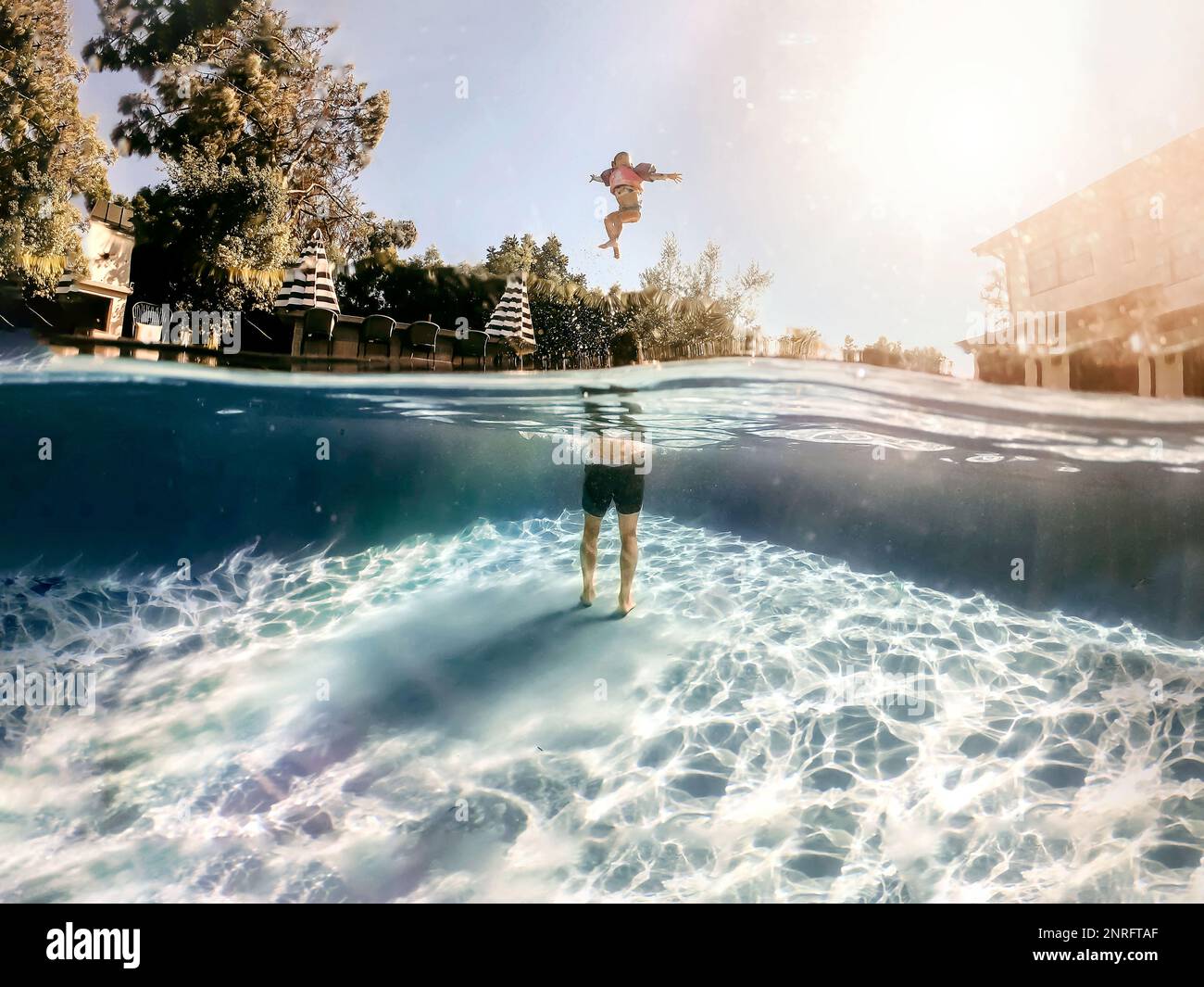 Dad throwing daughter in the pool Stock Photo Alamy