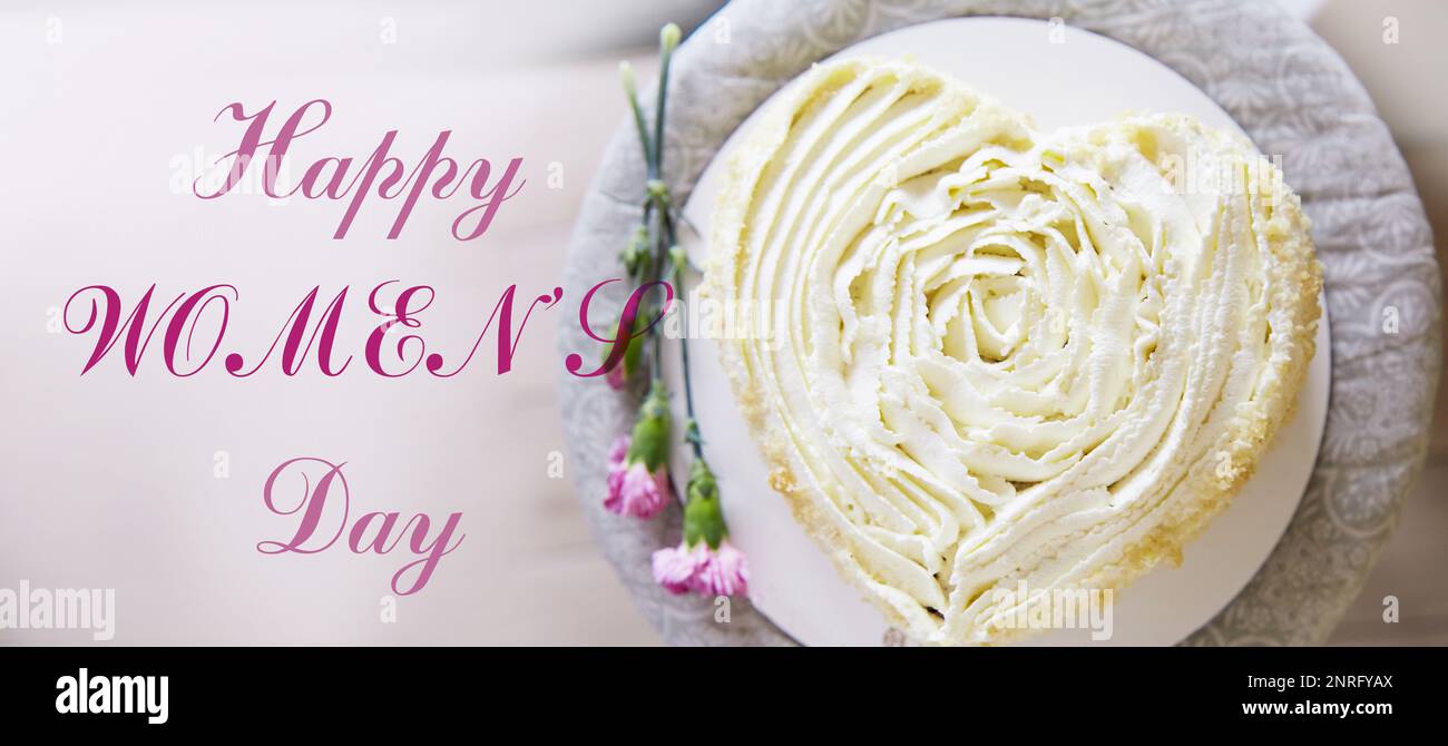 Heart shape cake with flowers and text Happy Womens day, extra wide banner Stock Photo