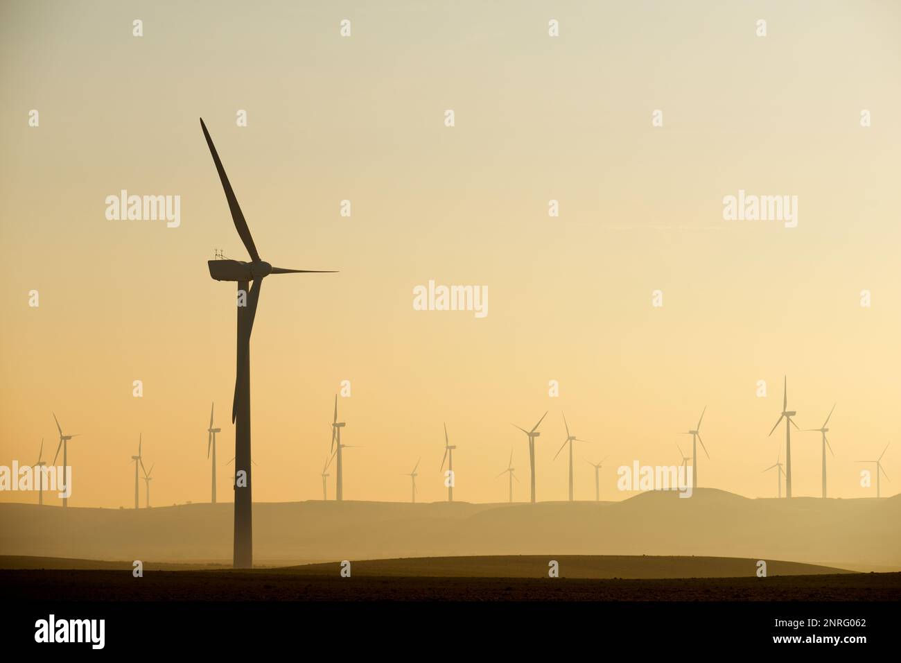 Silhouettes of a group of wind turbines at sunrise Stock Photo - Alamy