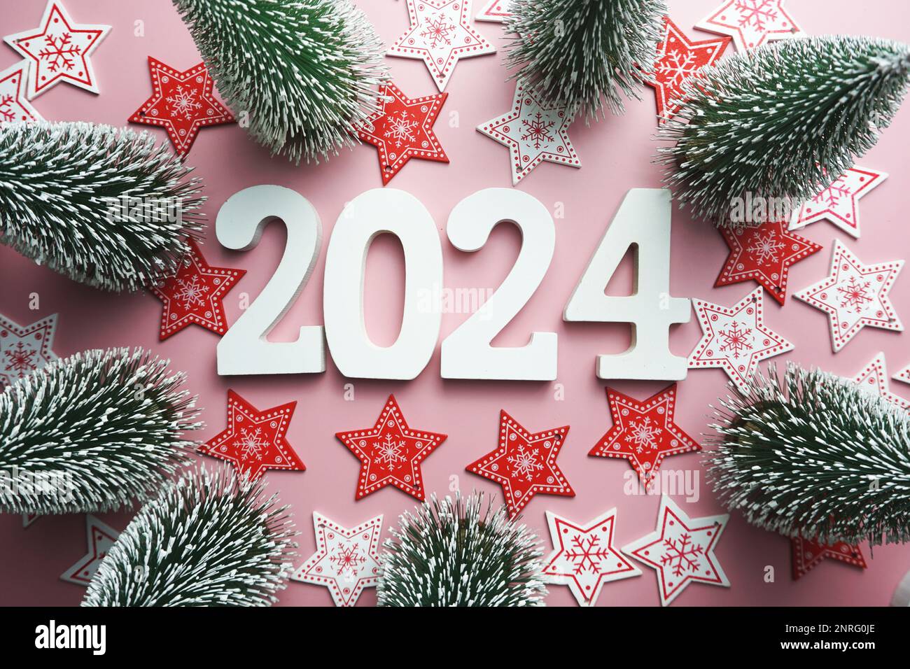 2024 Happy New Year and Christmas decoration on pink background Stock