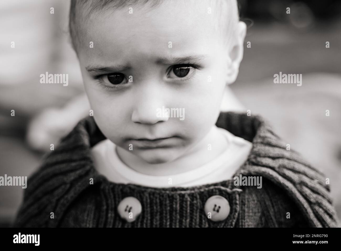 B&W Close up of Caucasian baby boy in a knitted sweater Stock Photo