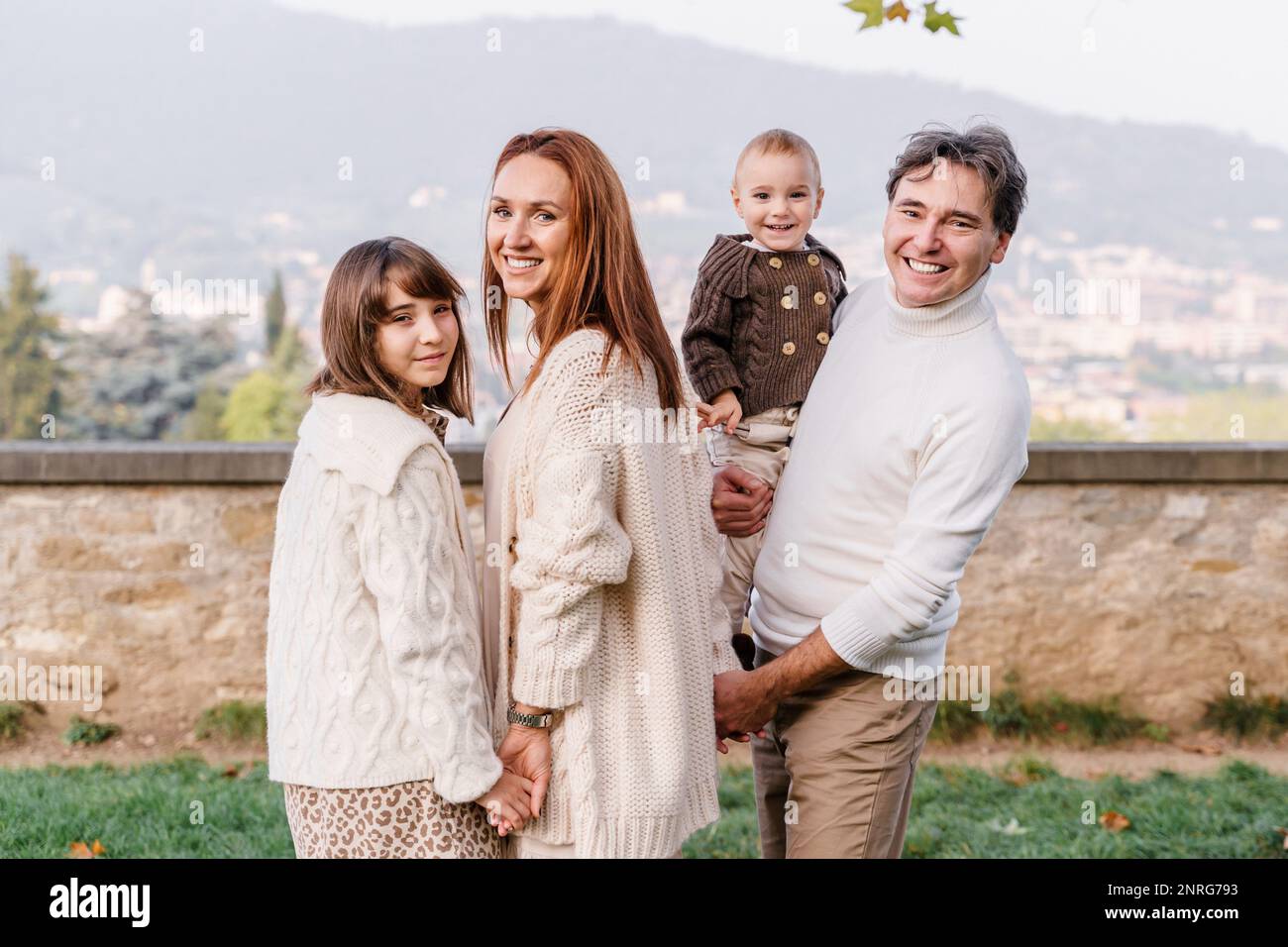 A young family with two children in a view point of Bergamo, Italy Stock Photo