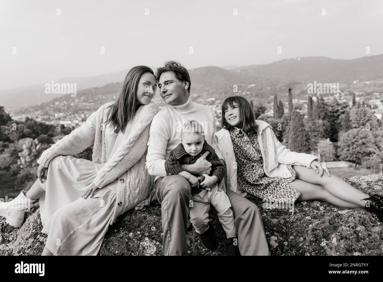 B&W portrait of family with two children in a view point of Bergamo Stock Photo