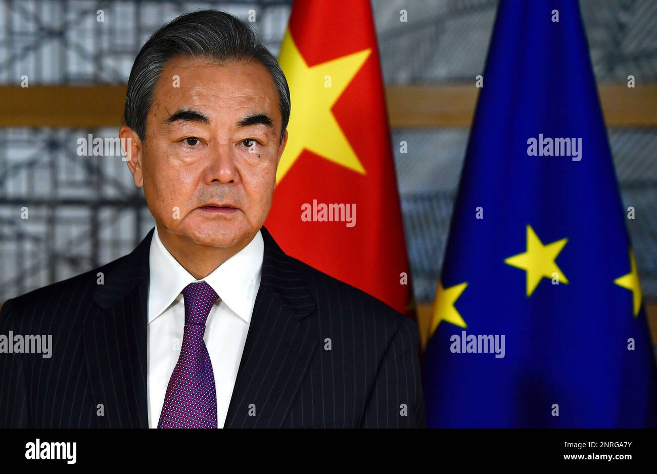 China's Foreign Minister Wang Yi stands next to the EU and Chinese ...