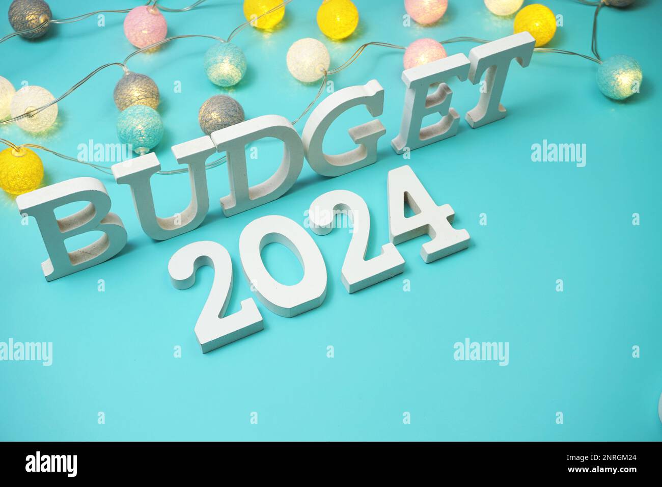 Budget 2024 Alphabet Letters With LED Cotton Balls Decoration On Blue   Budget 2024 Alphabet Letters With Led Cotton Balls Decoration On Blue Background 2NRGM24 