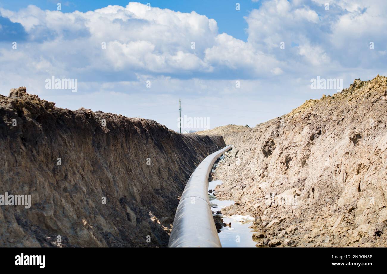 Natural gas pipeline construction work. A dug trench in the ground for