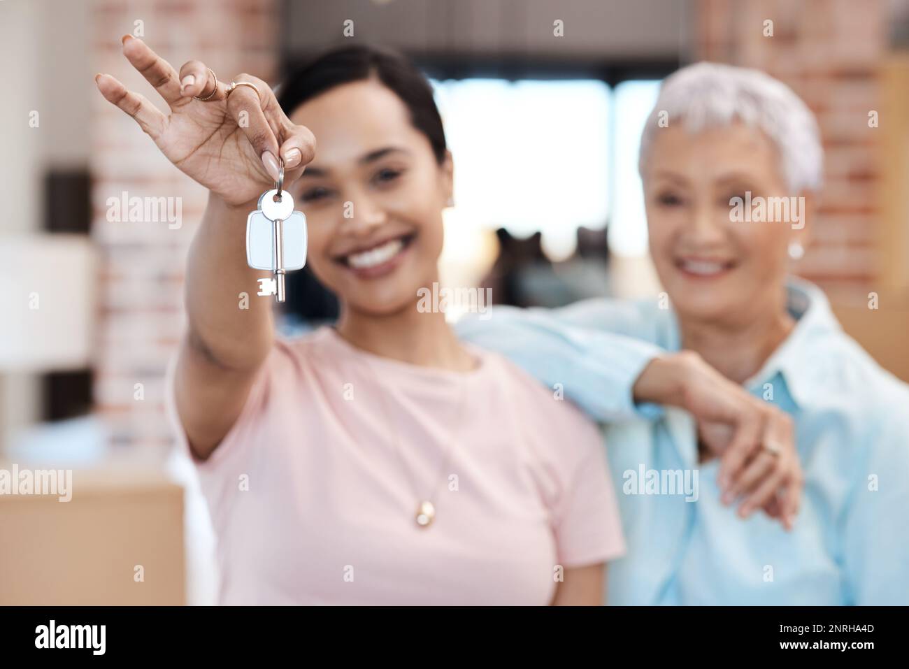 Guess whos got a brand new home. a senior woman standing next to her ...