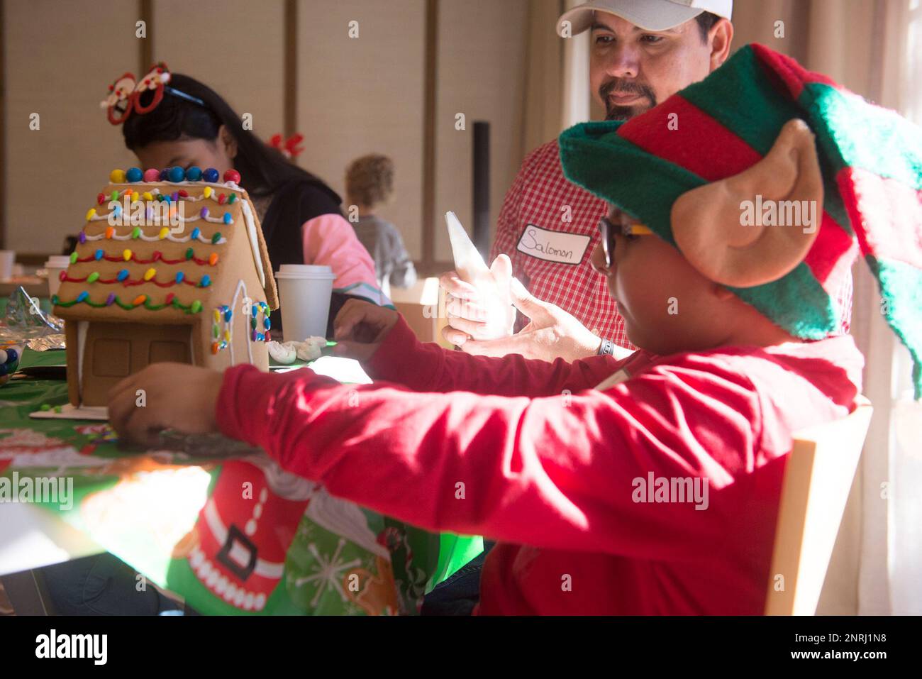 Jonathan Medina, 6, and his father Salomon Medina decorate a gingerbread  house during Camp Sunshine's event at the Alida Hotel on Sunday. Camp  Sunshine is a state-wide program that offers support, recreation