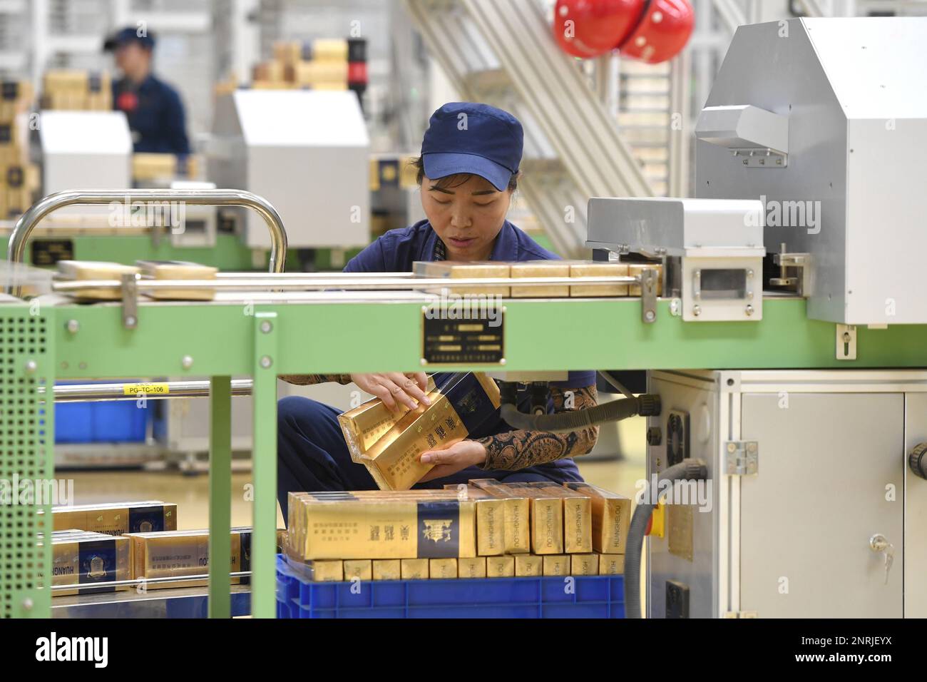 cigarette production line An employee works on the cigarette production line at a China Tobacco  subsidiary in Wuhan in central China's Hubei province Thursday, Nov. 28,  2019. China produced 1.85 trillion cigarettes in the first