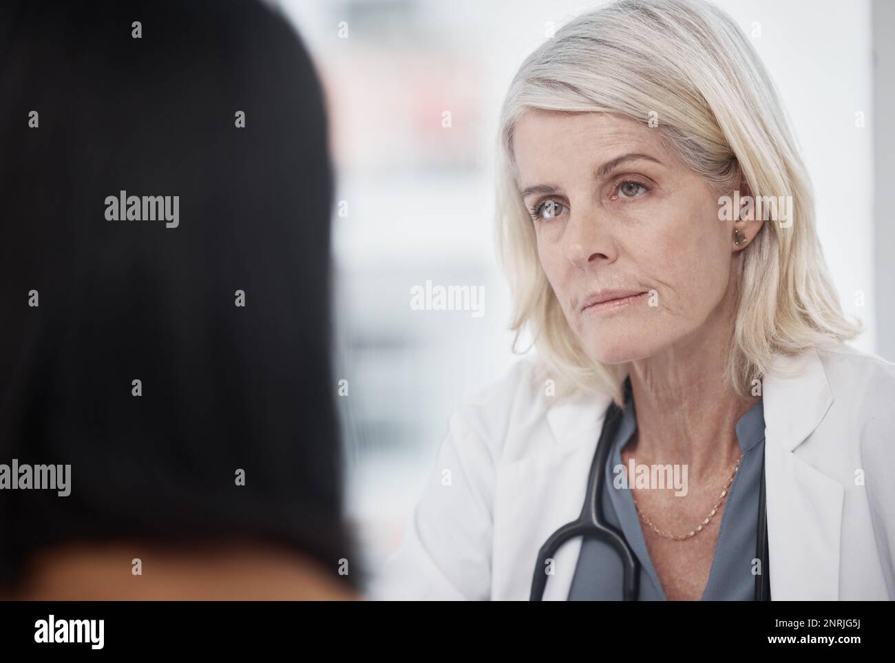 First talk, then treat. a doctor having a consultation with a patient ...