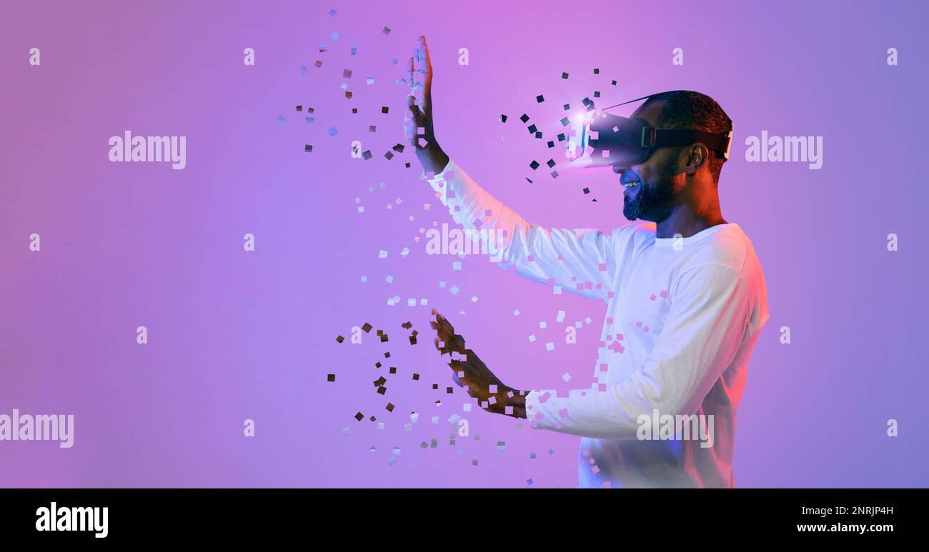 Black man in VR headset touching something invisible, copy space Stock Photo