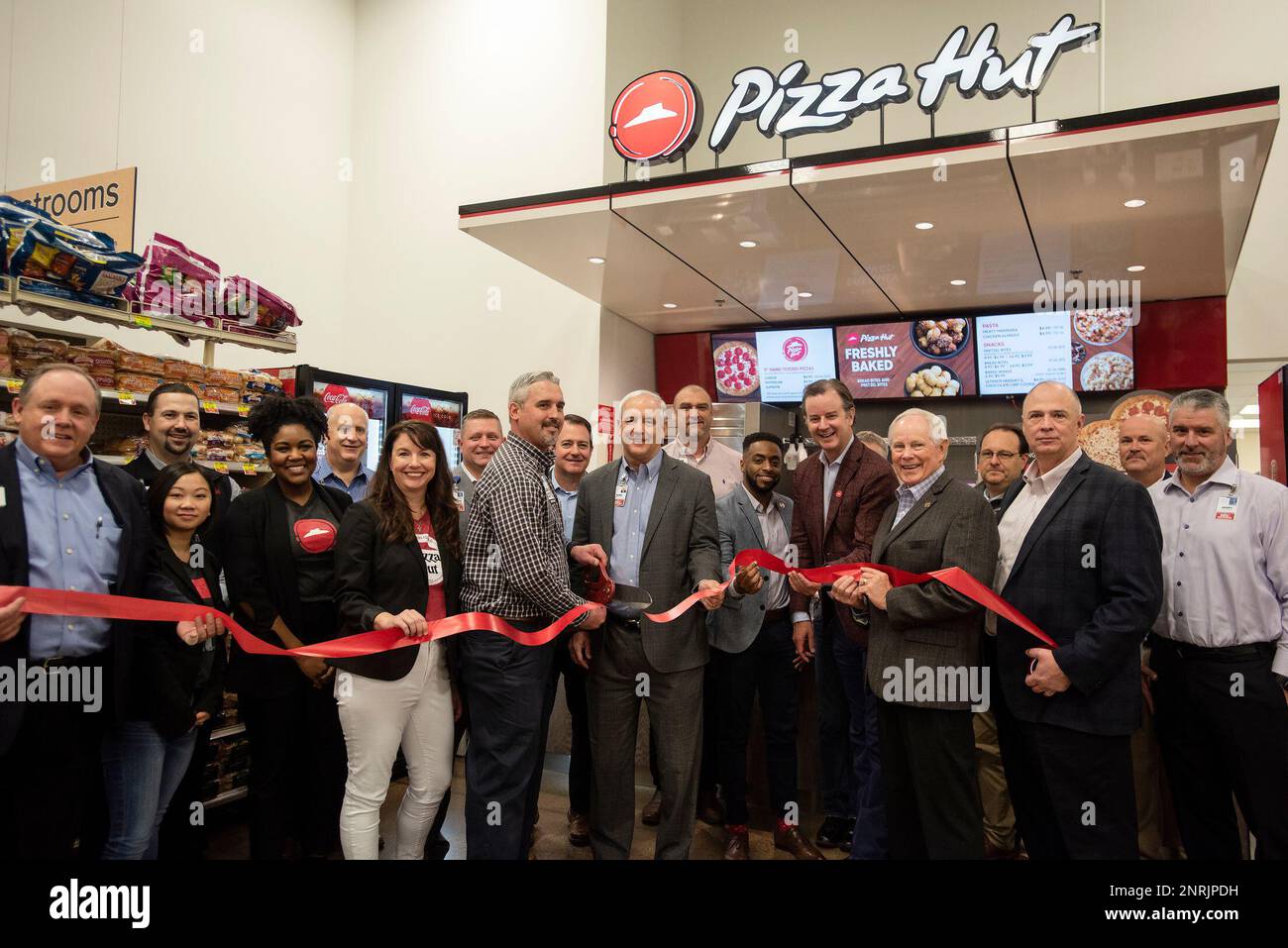 Representatives from Brookshire Grocery Co. and Pizza Hut gather for a