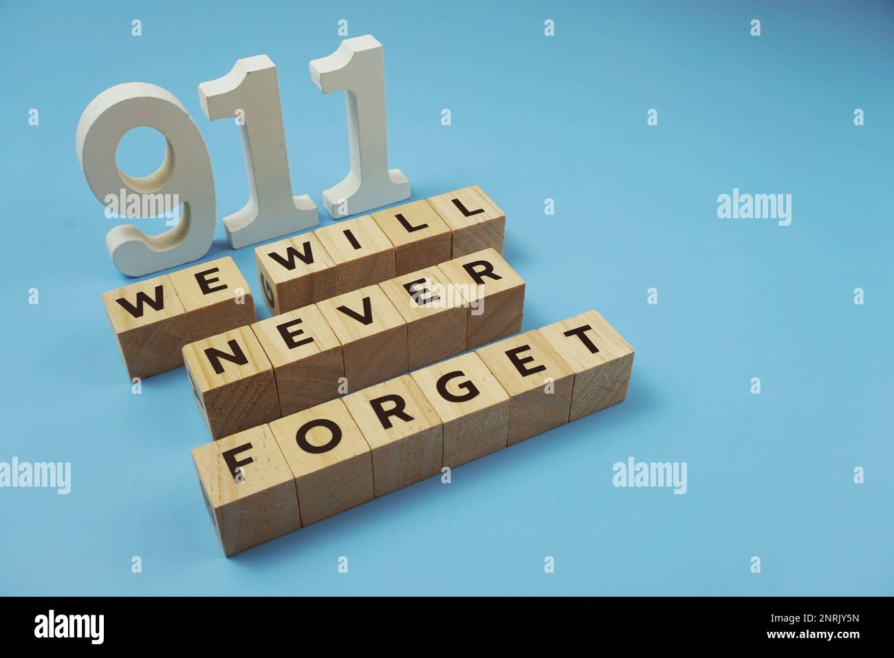 911 We will Never Forget Word alphabet letters on blue background Stock