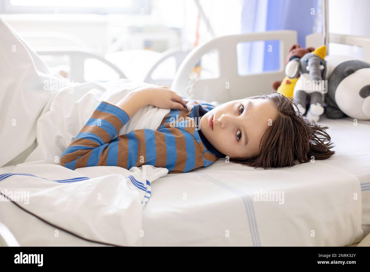 Preteen child, boy, lying in hospital with fractured thoracic spine