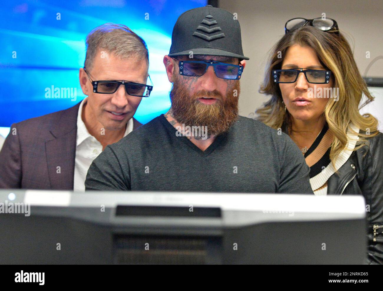 Glenn Stearns, 51, from left, R.J. Messenger, 31, and Glenn's wife Mindy  Stearns, 51, use 3D glasses to view an augmented reality program used in  science classes at Mercyhurst Prep, Thursday, Nov.