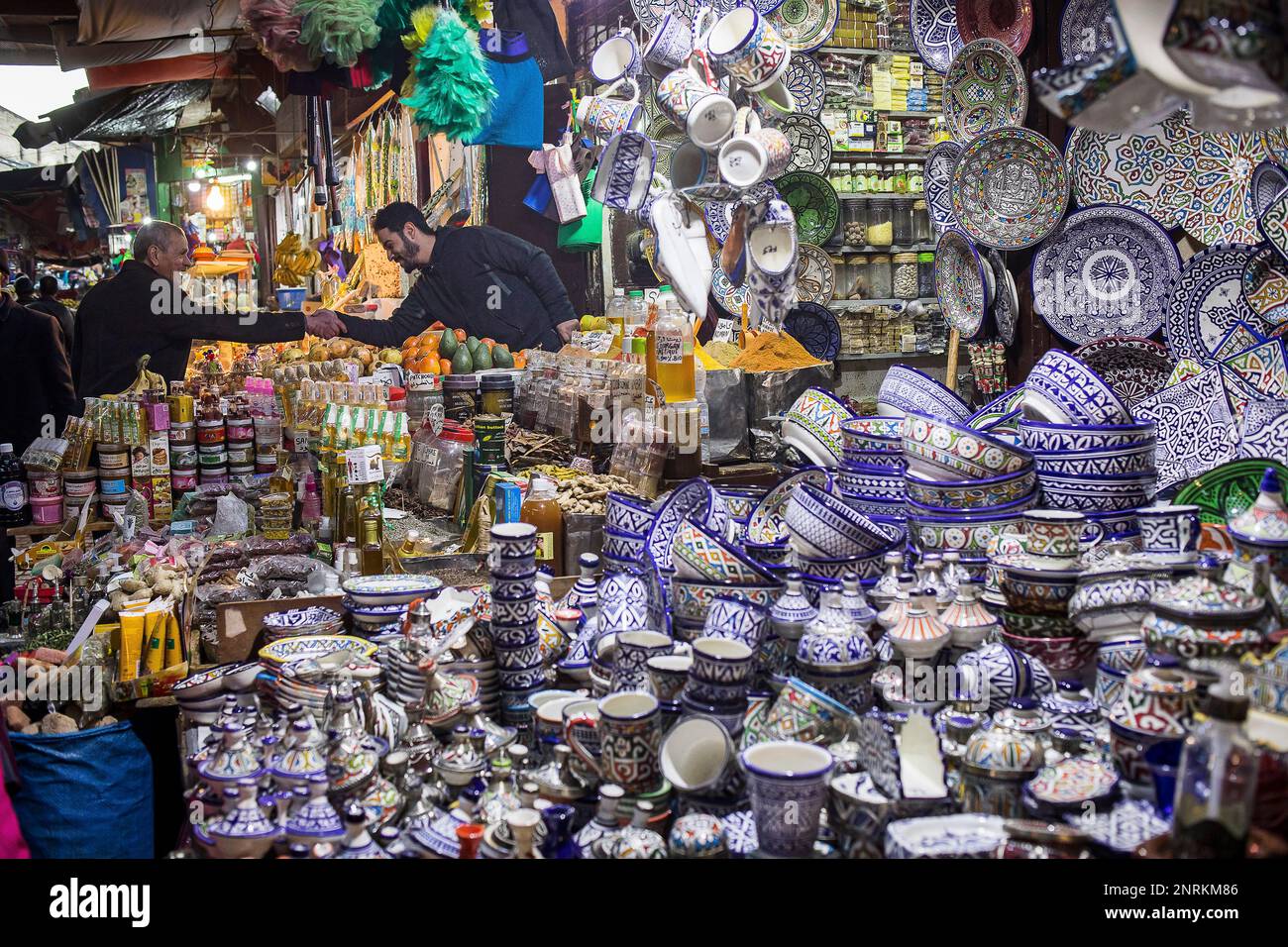 Friends greeting each other, market, ceramic and pottery shop, medina, Fez. Morocco Stock Photo