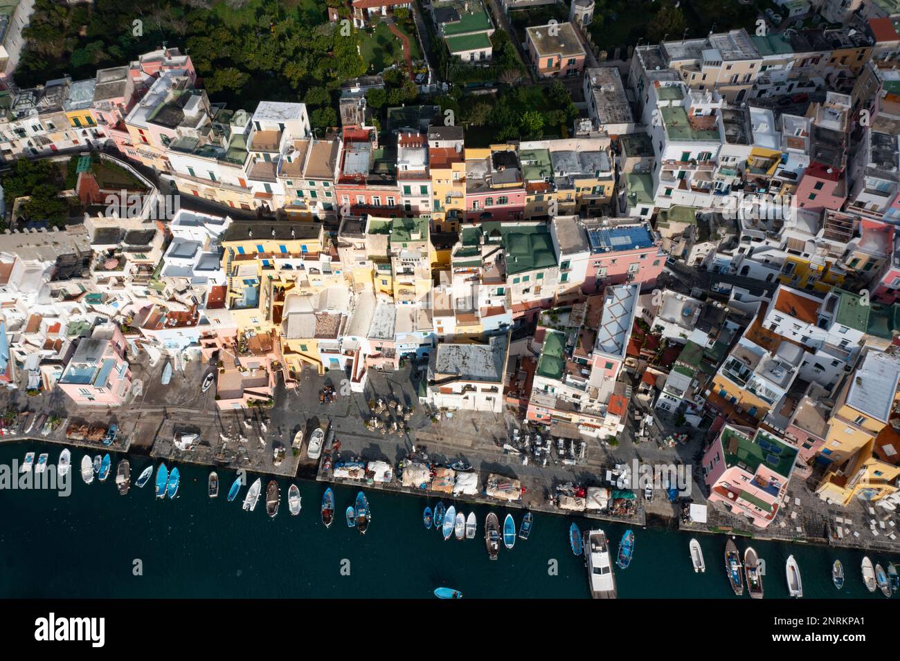 View of the Port of Corricella with lots of colorful houses on a sunny day in Procida Island, Italy. Stock Photo
