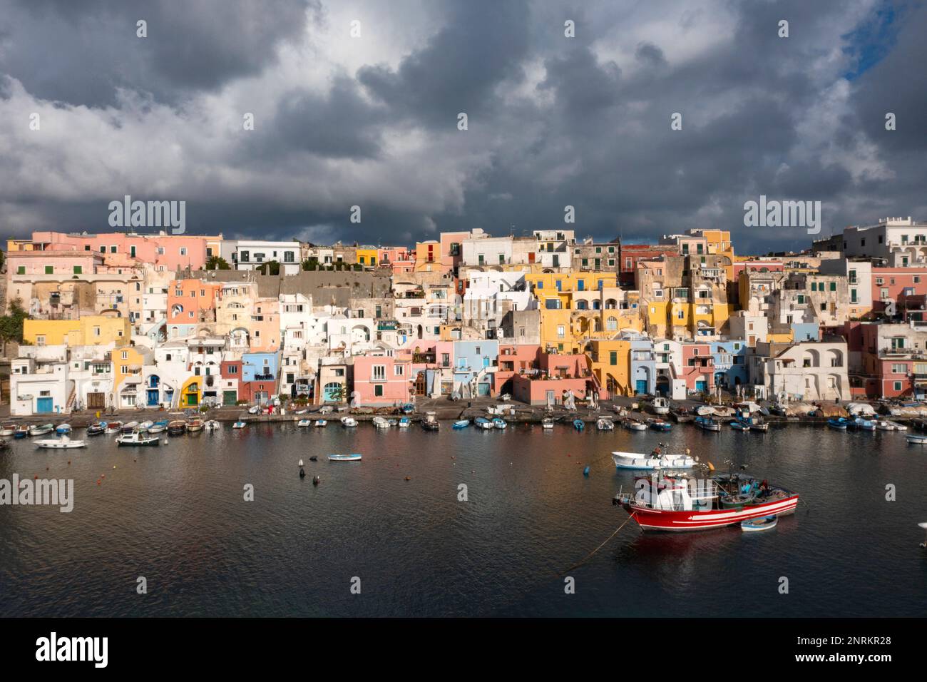 View of the Port of Corricella with lots of colorful houses on a sunny day in Procida Island, Italy. Stock Photo