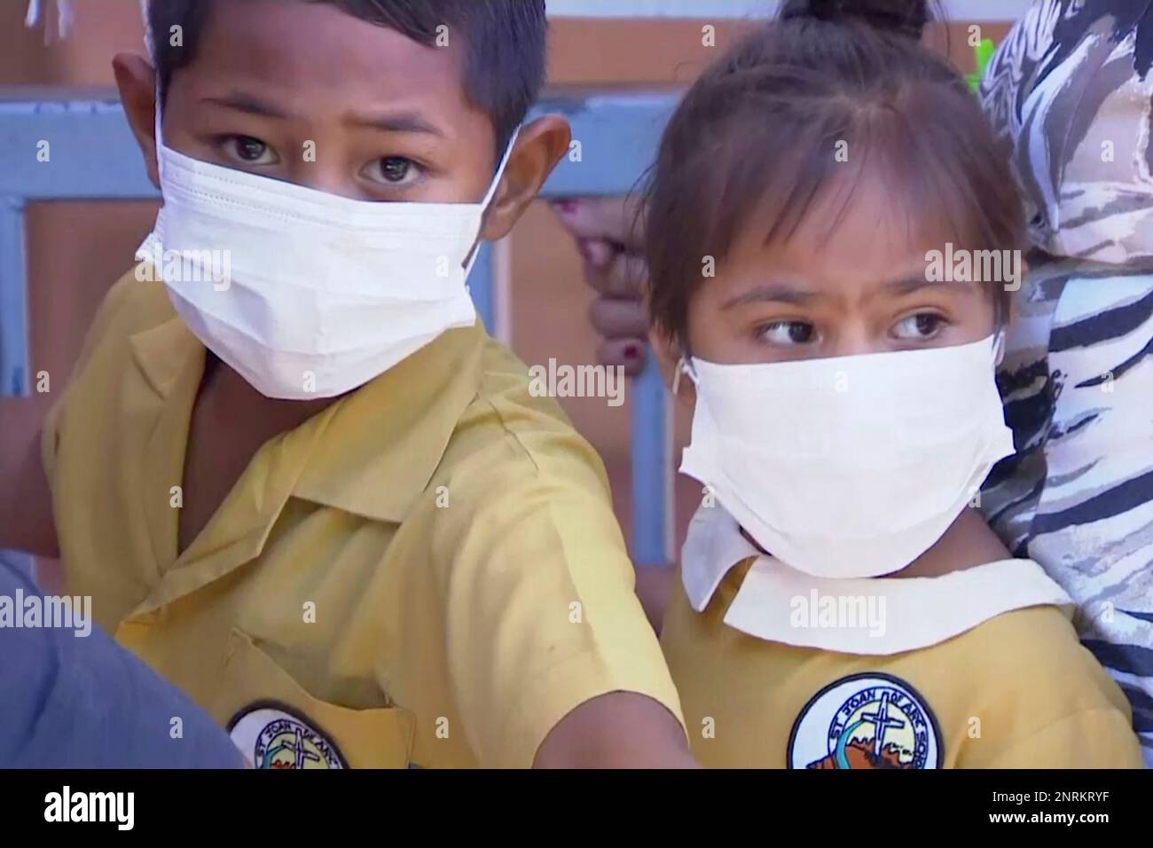 In this November 2019, image from video, masked children wait to get vaccinated at a health clinic in Apia, Samoa