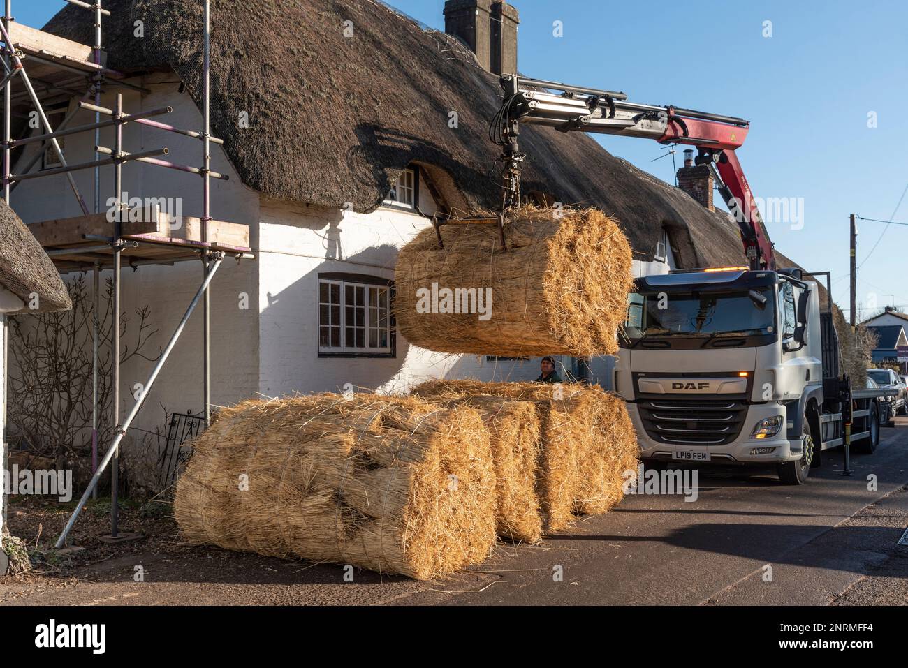 Hampshire, England, UK. 2023. Bales of thatching straw being offloaded