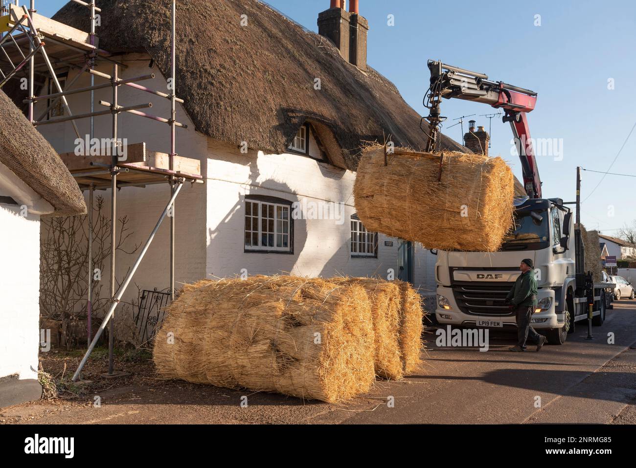 Hampshire, England, UK. 2023. Bales of thatching straw being offloaded