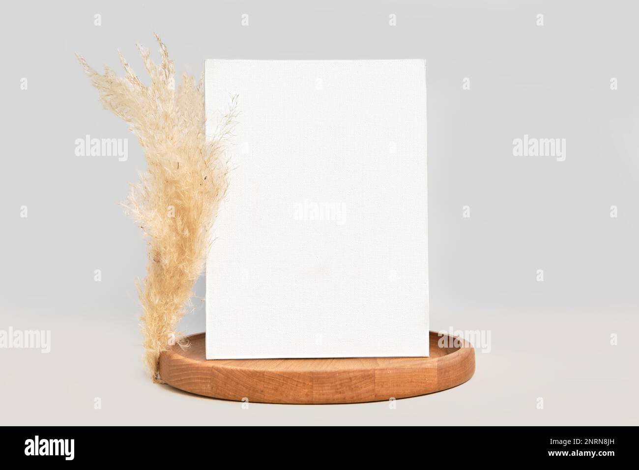 Blank Greeting Card, Invitation Mockup. Front view. Dry Pampas Grass Modern Wooden Plate, Paper