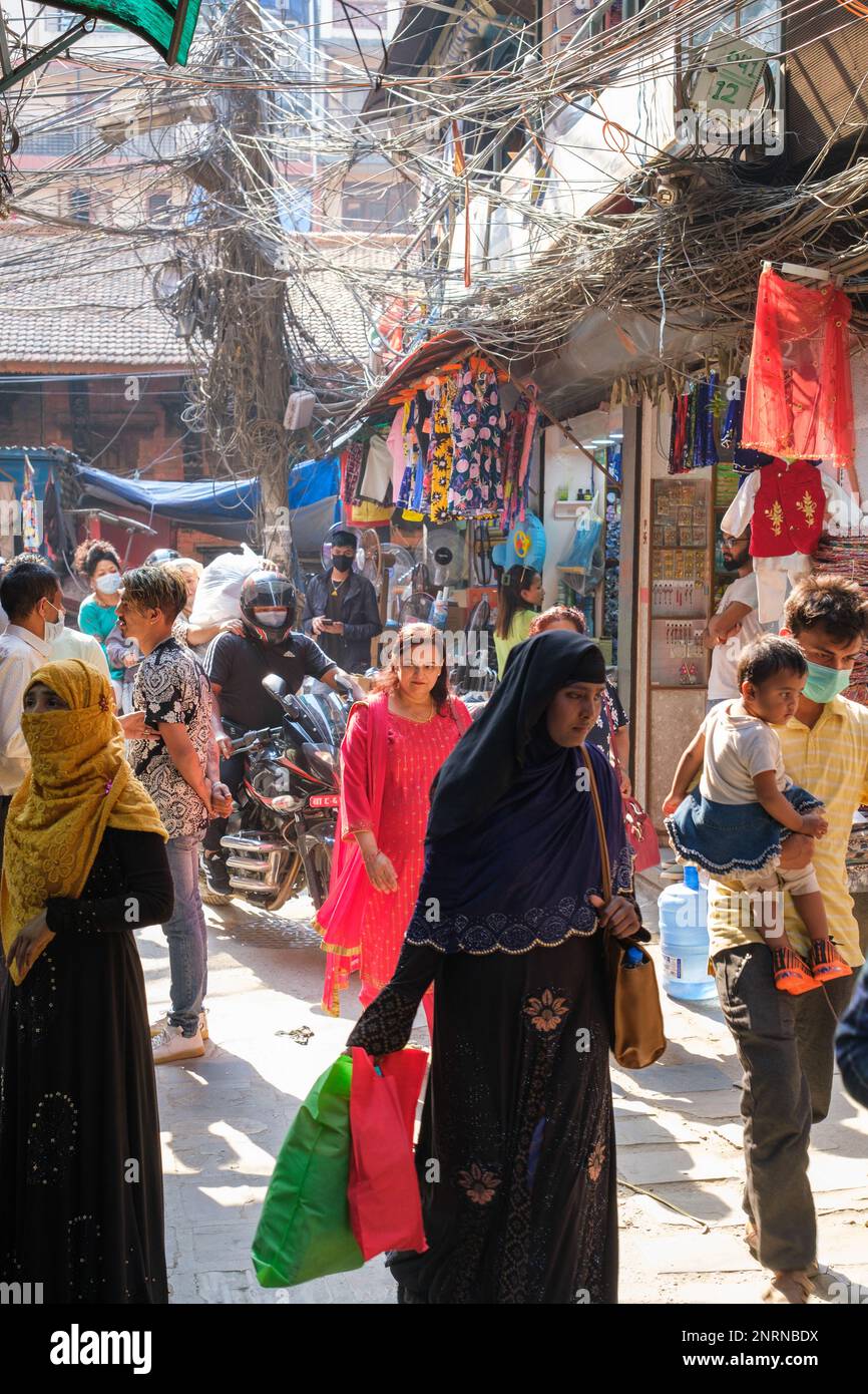 Kathmandu, Nepal, 04 23 2022 A woman in traditional clothing walking through Kathmandu bazaar