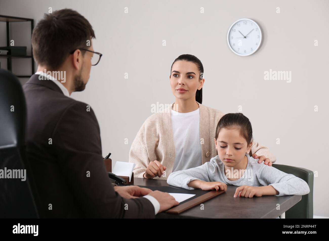 Mother and daughter having meeting with principal at school Stock Photo