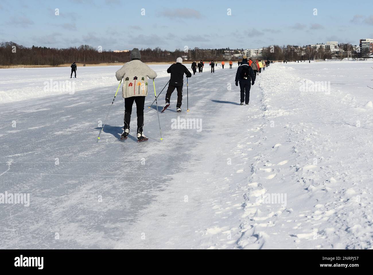 ice skating on Tuusul lake in Jarvenpaa on a sunny winter day February 26, 2023 Stock Photo