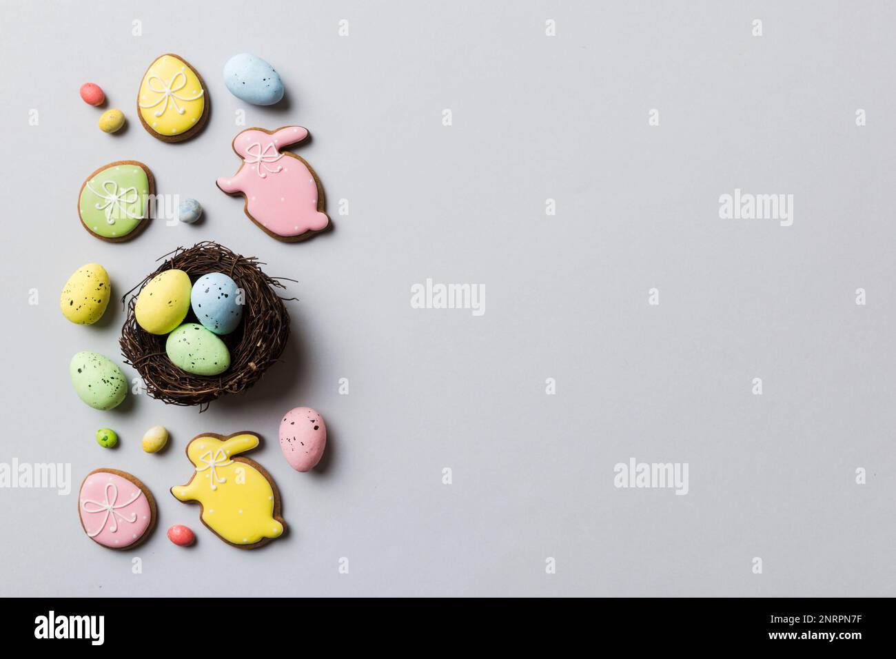 Colorful easter eggs in nest on table background with copy space top ...