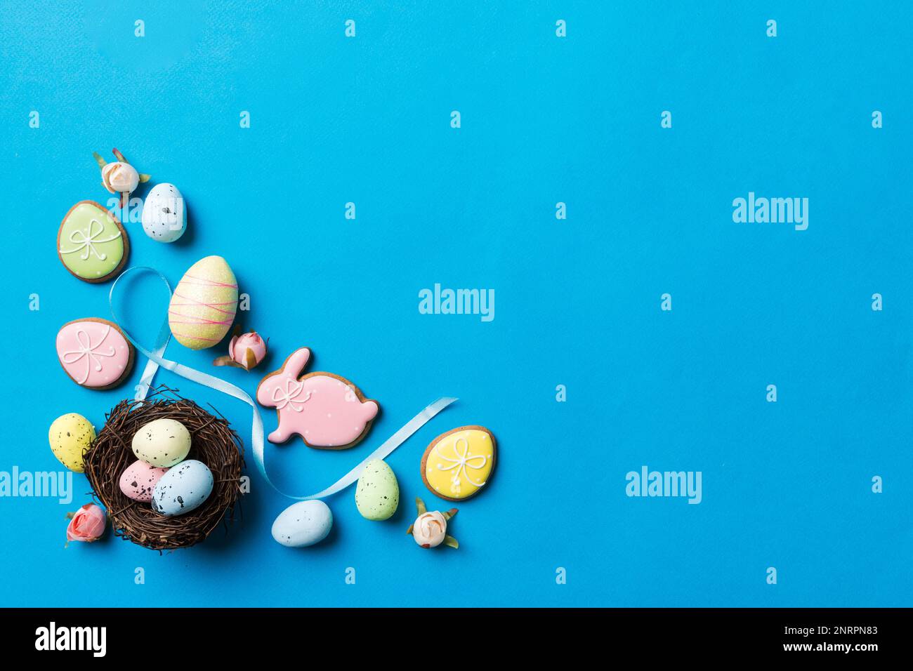 Colorful easter eggs in nest on table background with copy space top ...