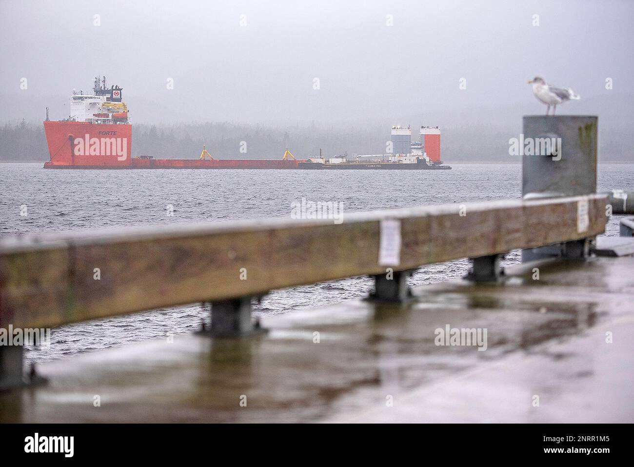 The tug Dale R. Lindsey positions the fuel barge Petro Mariner alongside the semisubmersible