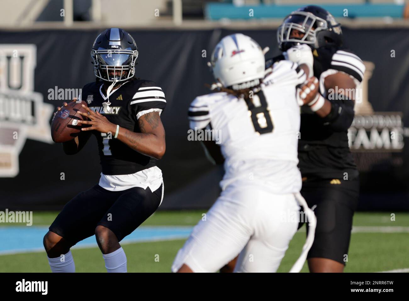 Team Robinson quarterback Larry Harrington (1) of Langston drops back