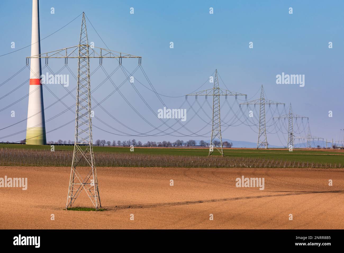 The energy transition requires more electricity pylons and wind turbines for the nuclear phase-out Stock Photo