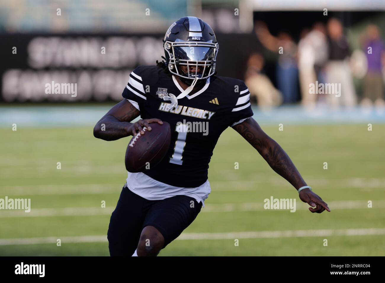 Team Robinson quarterback Larry Harrington (1) of Langston scrambles